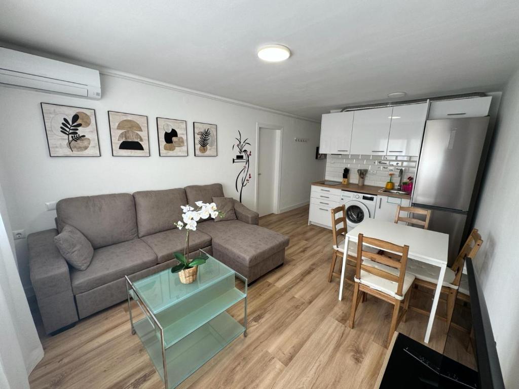 a living room with a couch and a table at Roger Apartamentos in Cambrils