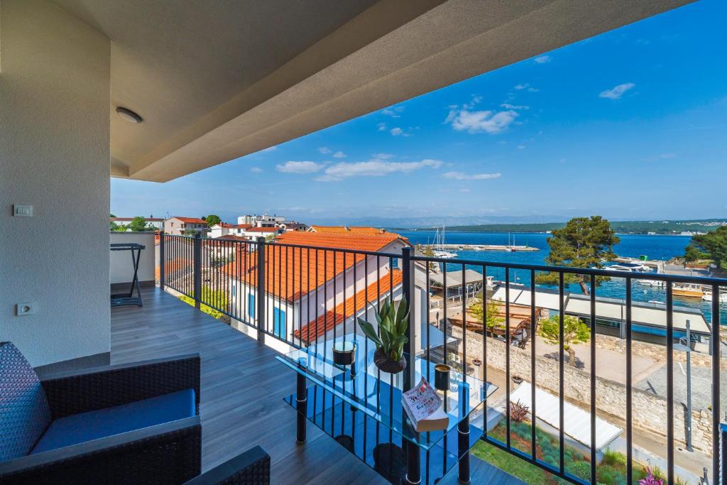 a balcony with a view of the ocean at Apartments Doris in Malinska