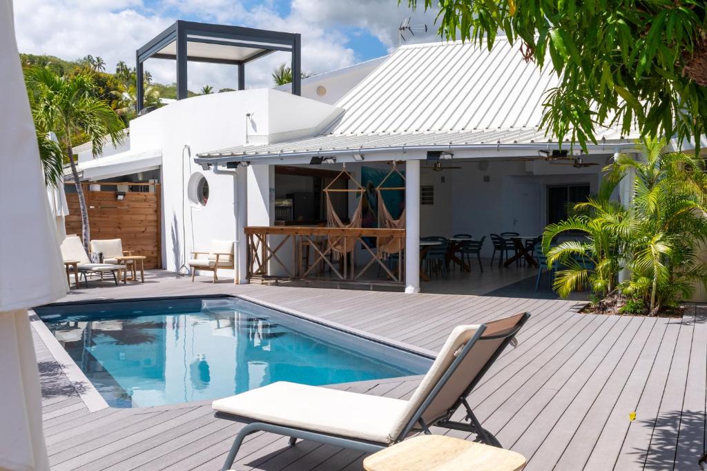 a house with a swimming pool and a deck at Ilot Bleu in Boucan Canot