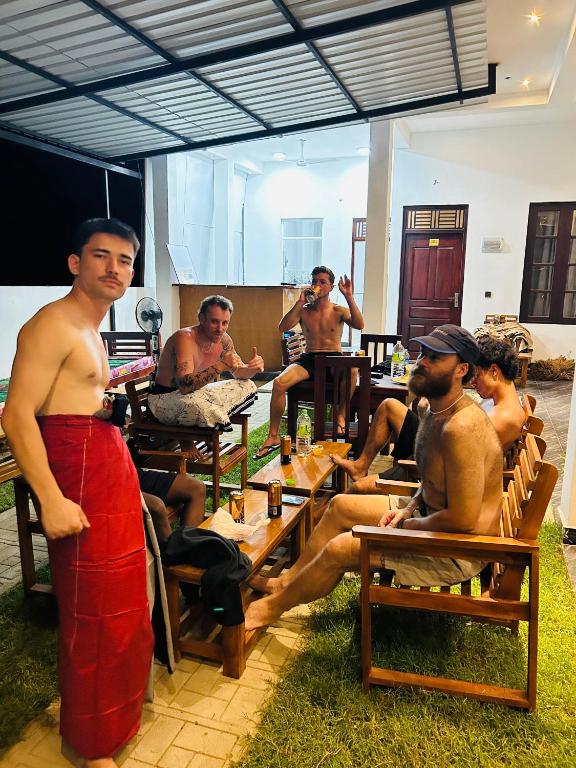 a group of men sitting at tables in a restaurant at Wake N Flow, Arugam Bay in Arugam Bay