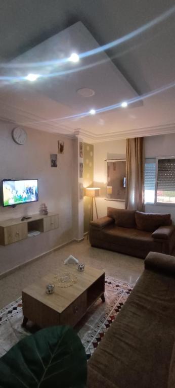 a living room with a couch and a tv at Cockpit in Le Kram