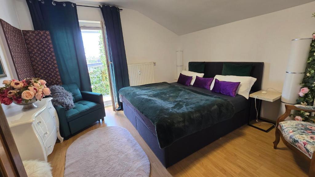 a bedroom with a bed with purple pillows and a couch at Radolfzell Bodensee in Radolfzell am Bodensee
