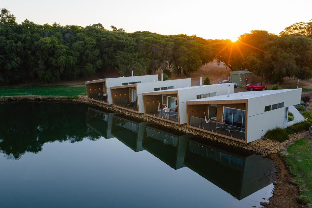 a house on a bridge over a body of water at Edge Luxury Villas in Wilyabrup