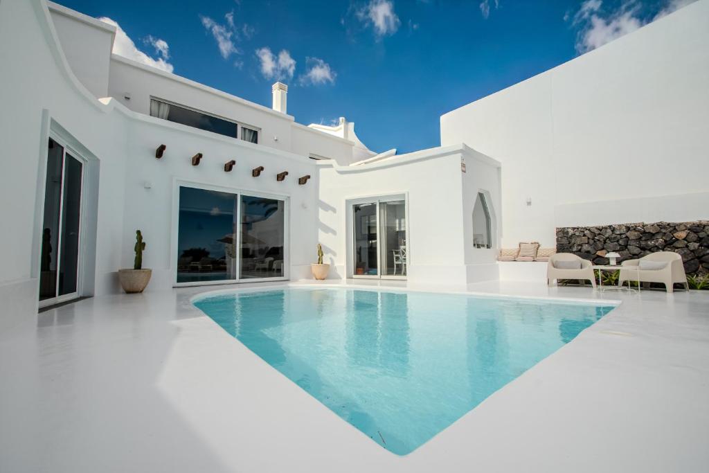 a white villa with a swimming pool at Villa Lore by Villalize in Teguise