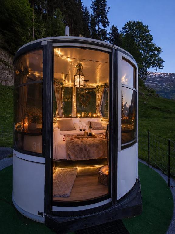a bus with a bedroom inside of it at Panorama Hotel Wagenkehr in Innertkirchen