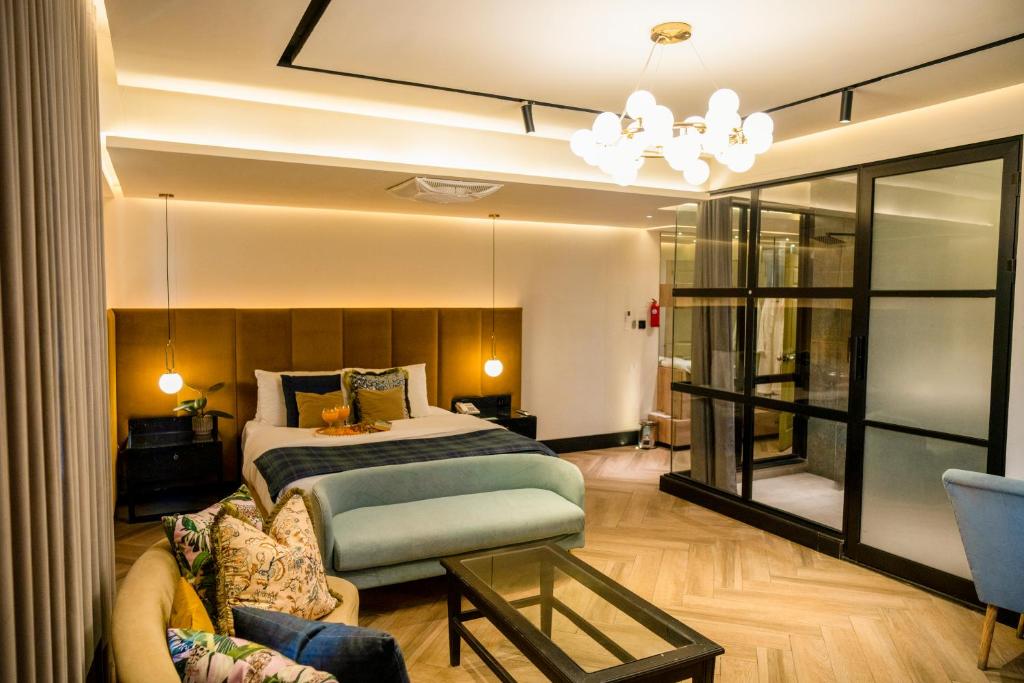 a hotel room with a bed and a couch at City Hotel in Abbottabad