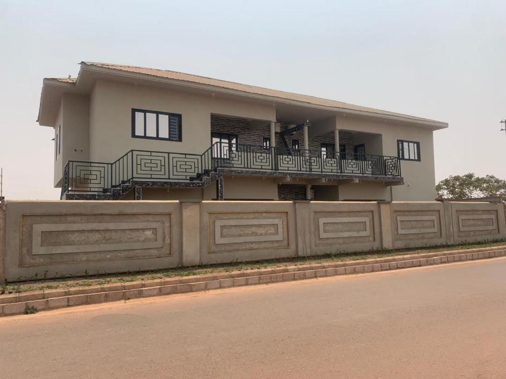 a house on the side of a fence at KATEL Green appartements in Kolwezi
