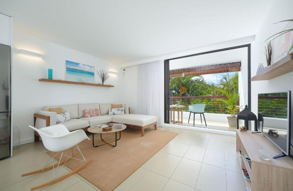 a living room with a couch and a table at Beautiful Flat in Mont Choisy in Mont Choisy