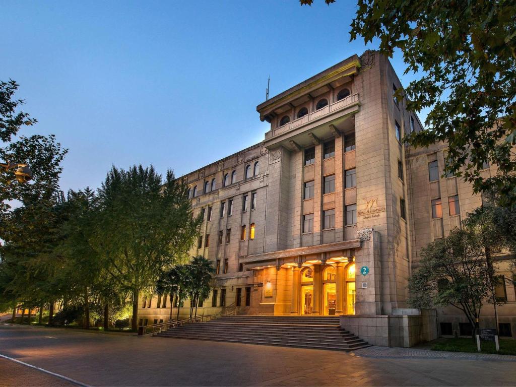 a large stone building with stairs in front of it at Grand Mercure Xian On Renmin Square in Xi'an