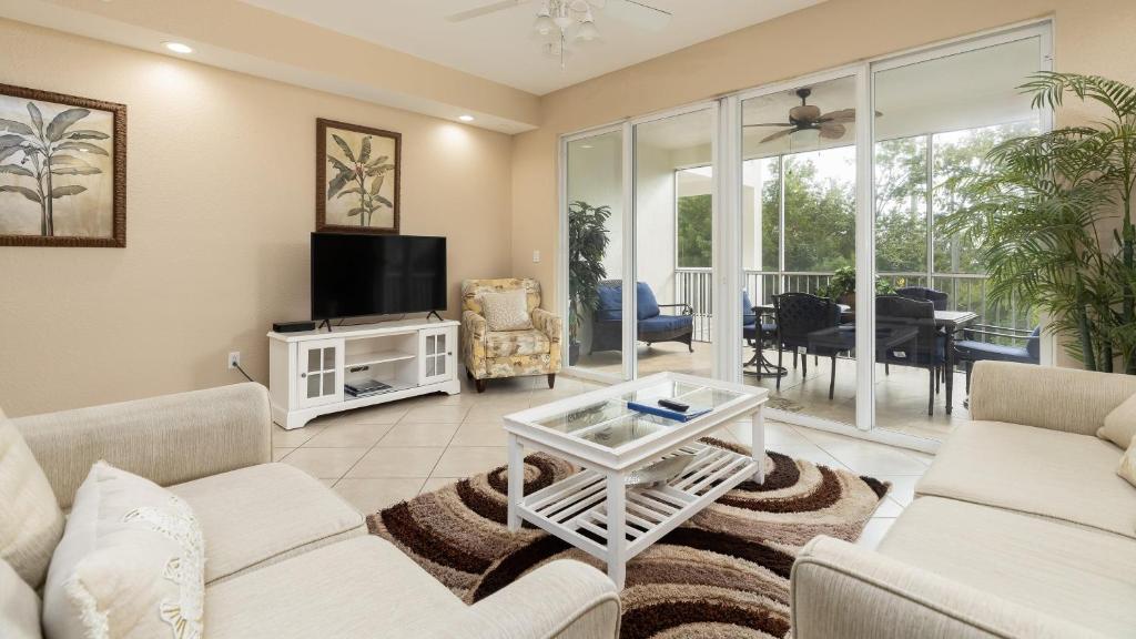 a living room with two couches and a tv at 611 Mariners Club in Key Largo