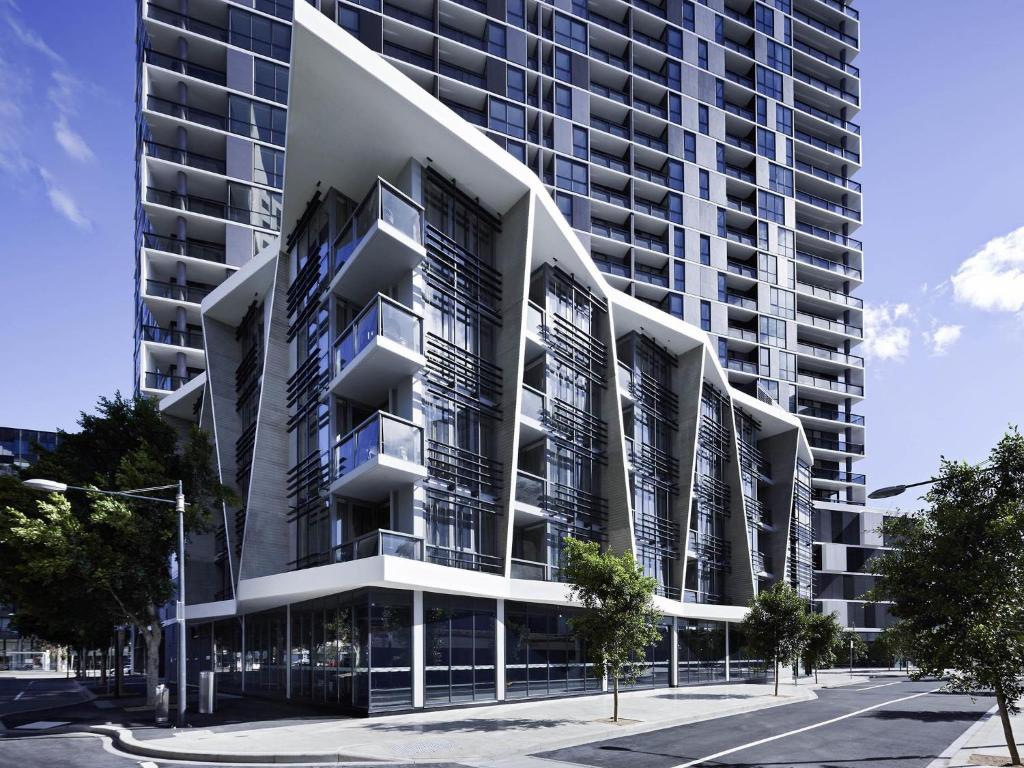 a large building with balconies on the side of it at The Sebel Residences Melbourne Docklands Serviced Apartments in Melbourne