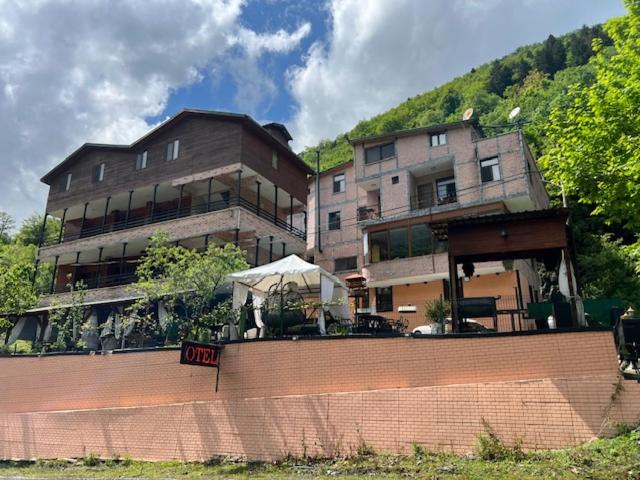 a large building in front of a building at Lapera Otel in Borçka