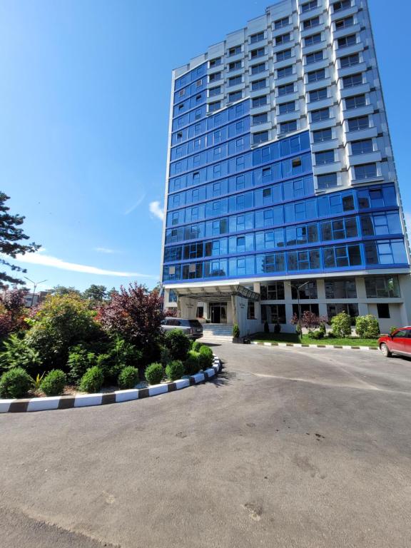 a tall building with a car parked in front of it at Olimp Sea View 607 in Olimp
