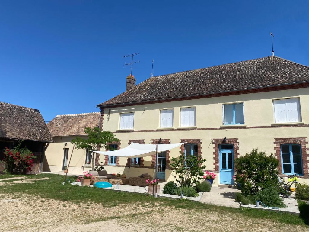 a large house with a garden in front of it at Les Terres Noires in Serville