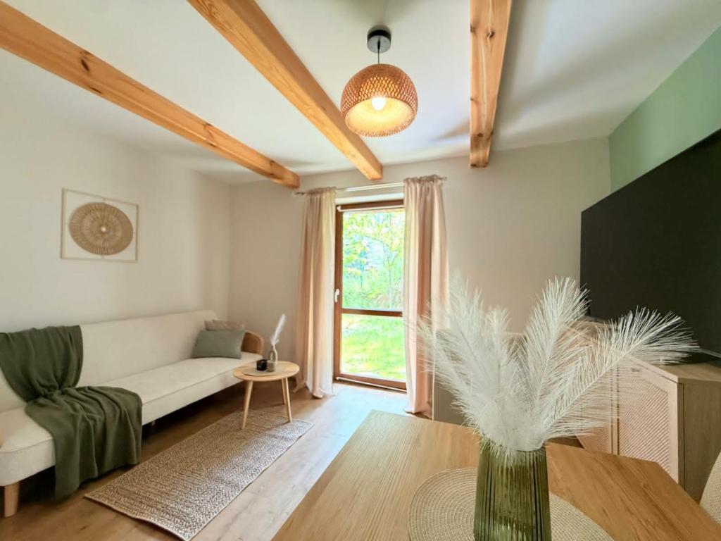 a living room with a couch and a table at Dom Skośna Kraśnik in Kraśnik