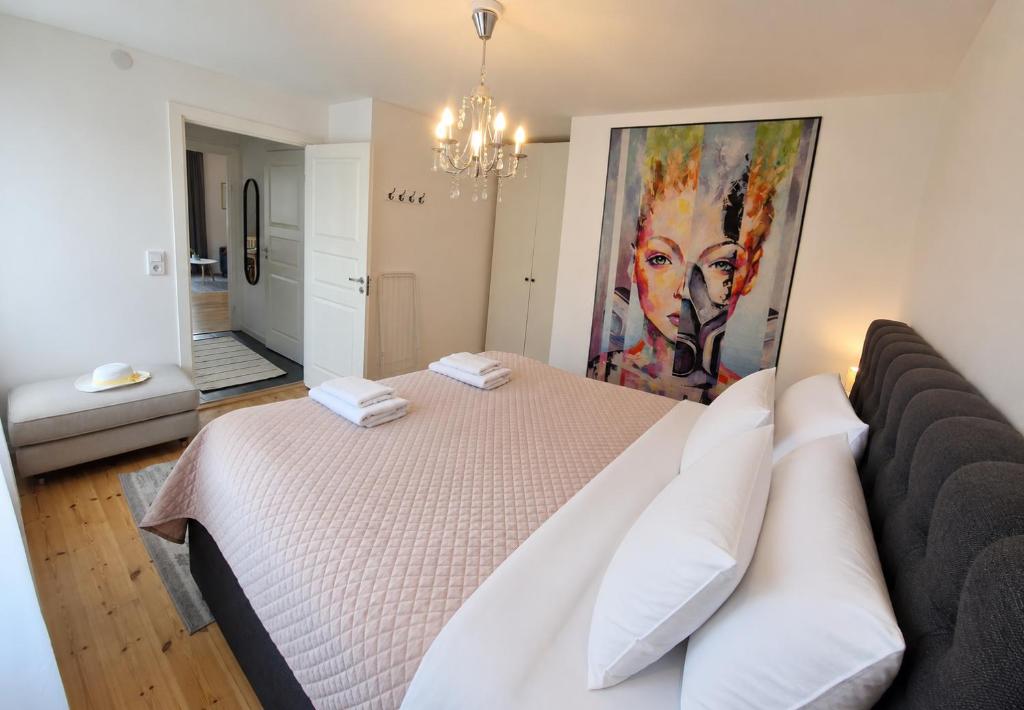 a bedroom with a bed and a painting on the wall at Central City Apartment A in Nyköping