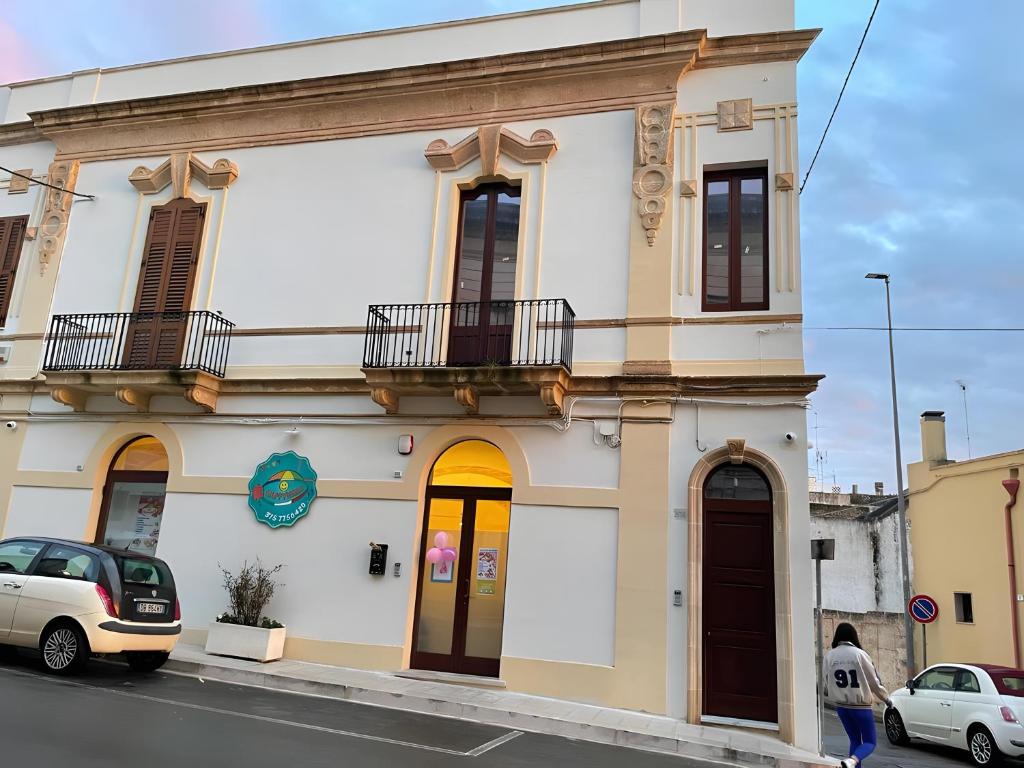 a building on a street with cars parked in front at Matinè Suite And Room in Matino