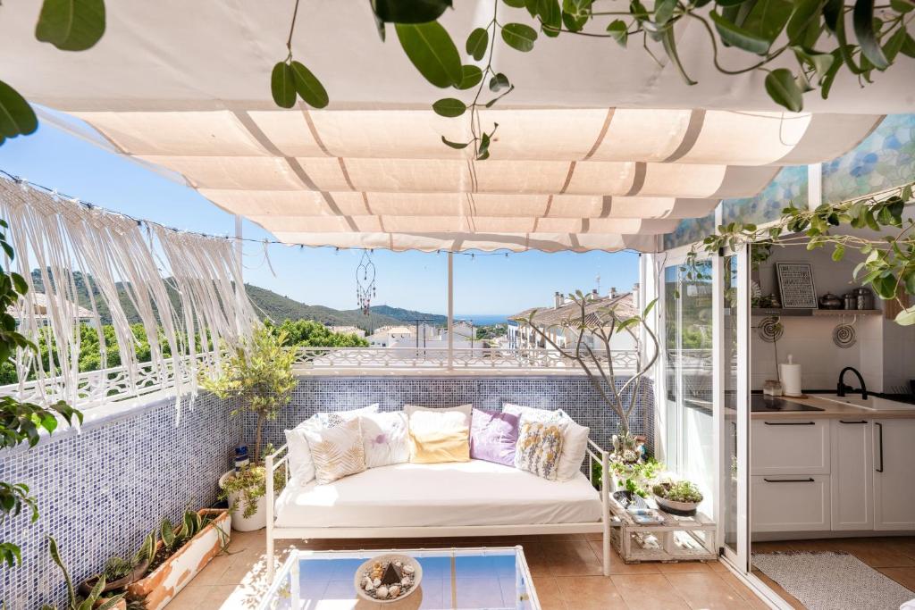 a living room with a couch on a balcony at Casa D’Amelia in Ojén