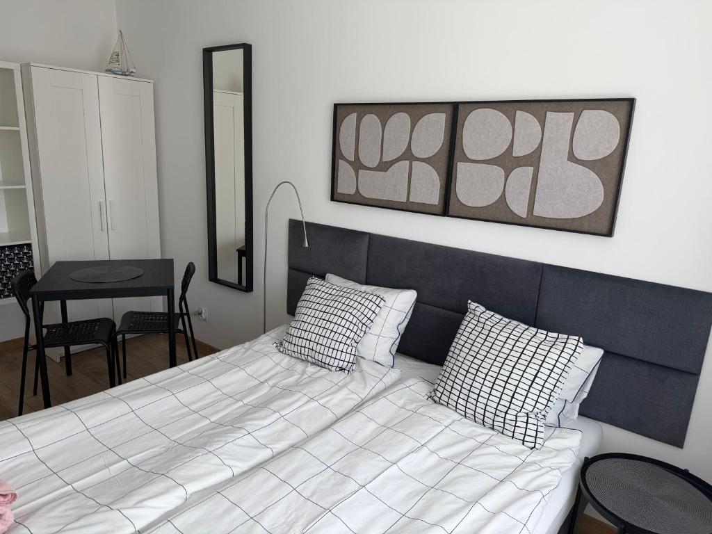 a bed with two pillows on it in a room at Apartamenty Dana in Pustkowo