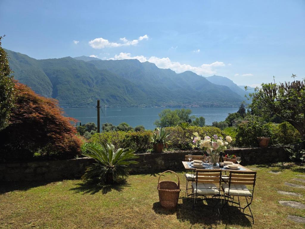 a table and chairs with a view of a lake at Ca Maria Celeste Apartment in Bellagio
