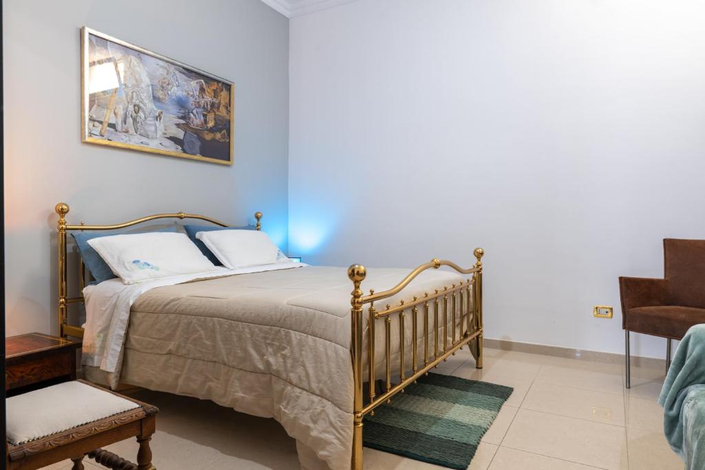 a bedroom with a bed and a picture on the wall at By Domy 2 Grottaglie in Grottaglie