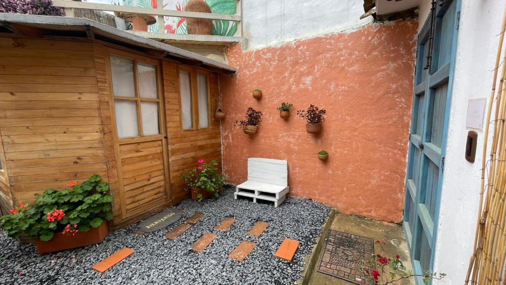 a white bench sitting in front of a building at Taida Chalet - Glamping in Villa de Leyva