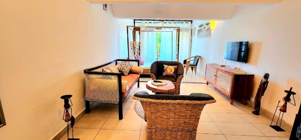 a living room with a couch and a table at Diani White Sands in Diani Beach