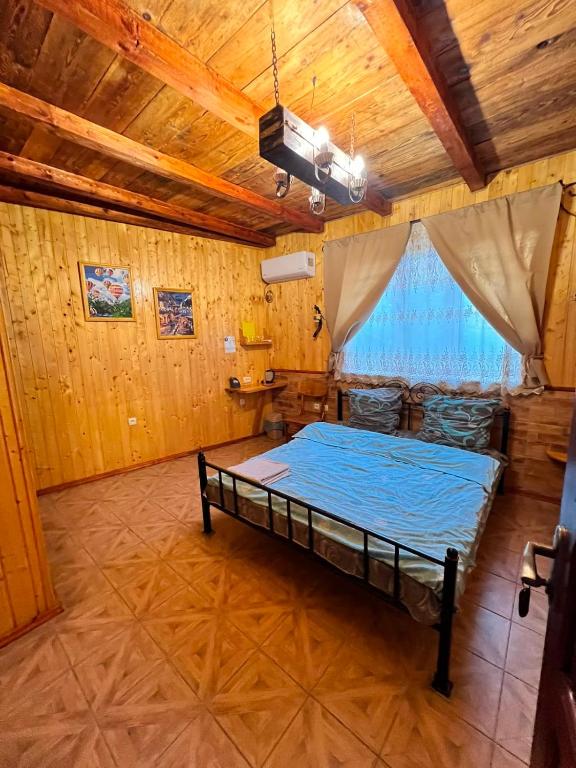 a bedroom with a bed and a wooden ceiling at Serce Kanyonu in Kamianets-Podilskyi