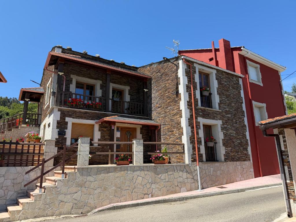 a brick building with a staircase in front of it at Casa do Lagar, Praia da Abrela in O Vicedo