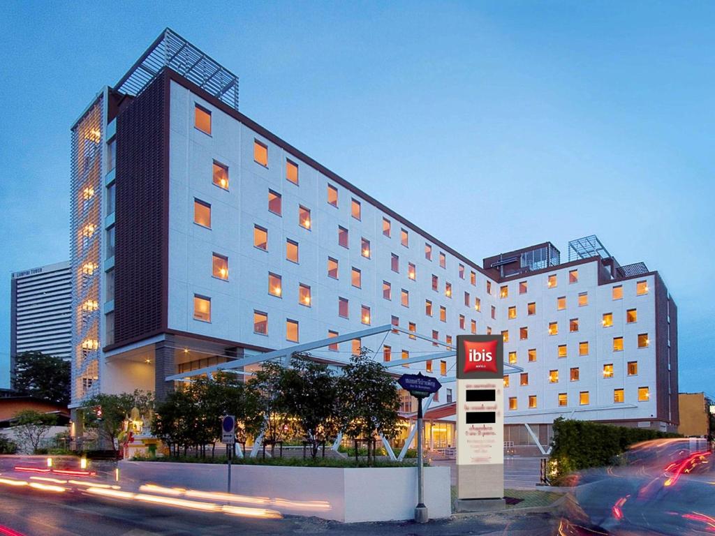 a hotel building with a sign in front of it at ibis Bangkok Sathorn in Bangkok