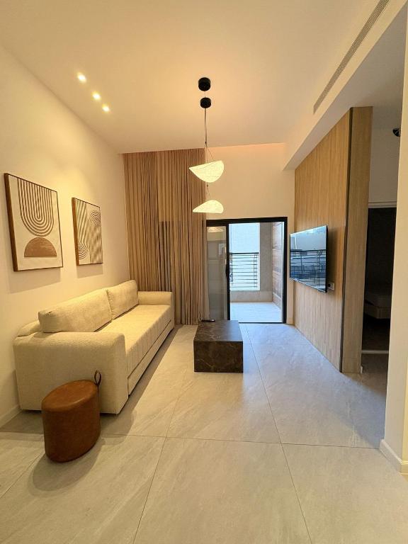 a living room with a couch and a table at דקוטה 11 Dakota in Eilat