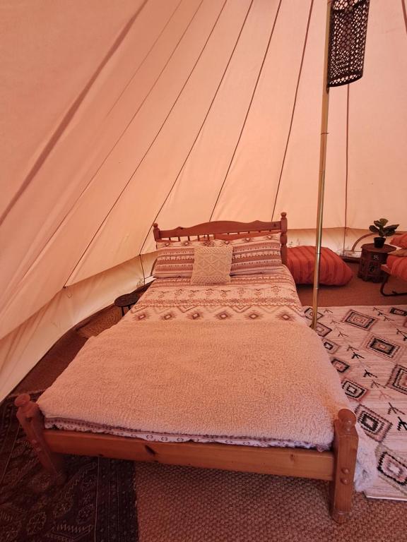 a bedroom with a bed in a tent at The Old Waterworks - Venus Bell Tent in Clare