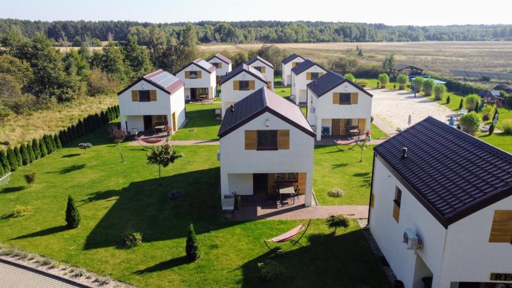 an aerial view of a row of houses on a green field at Domki Lawendowe in Łeba