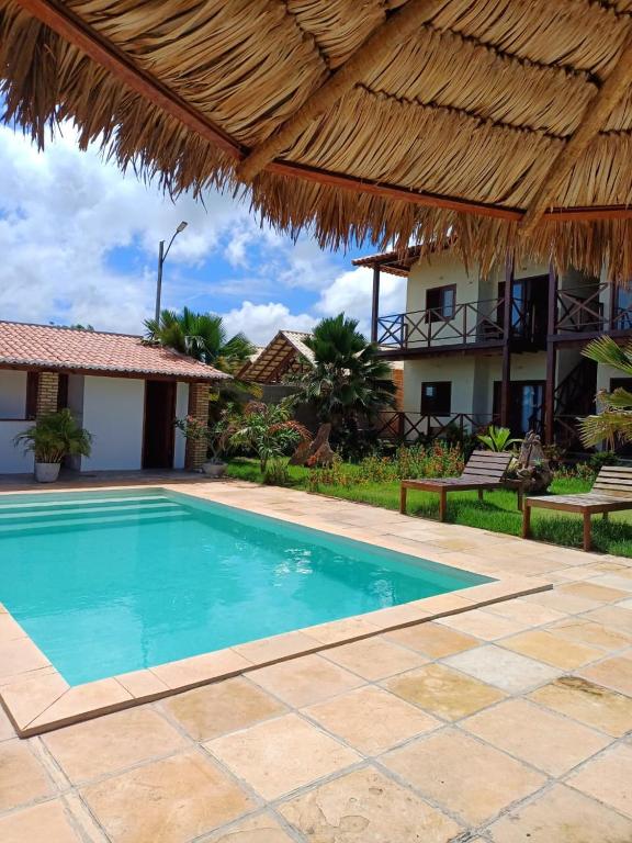 a villa with a swimming pool and a resort at Pousada Makai - Cajueiro da Praia in Barra Grande