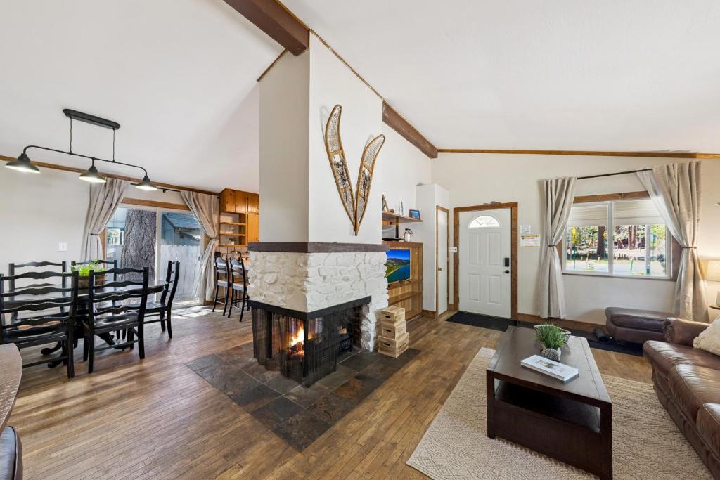 a living room with a fireplace and a dining room at Cozy Pines & Paths Retreat in South Lake Tahoe