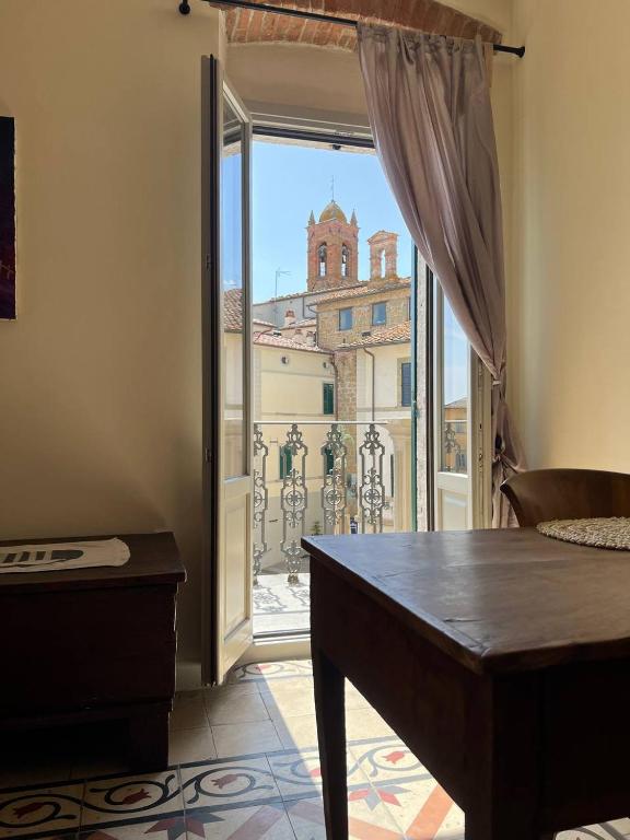 a room with a door open to a balcony at La Terrazza Sul Monte in Monte San Savino