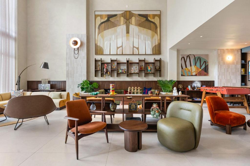a lobby with chairs and a table in a room at Domus Brickell Park in Miami