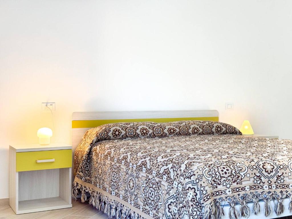 a bedroom with a bed and a yellow night stand at Dimora Fonte Grande in Lanciano