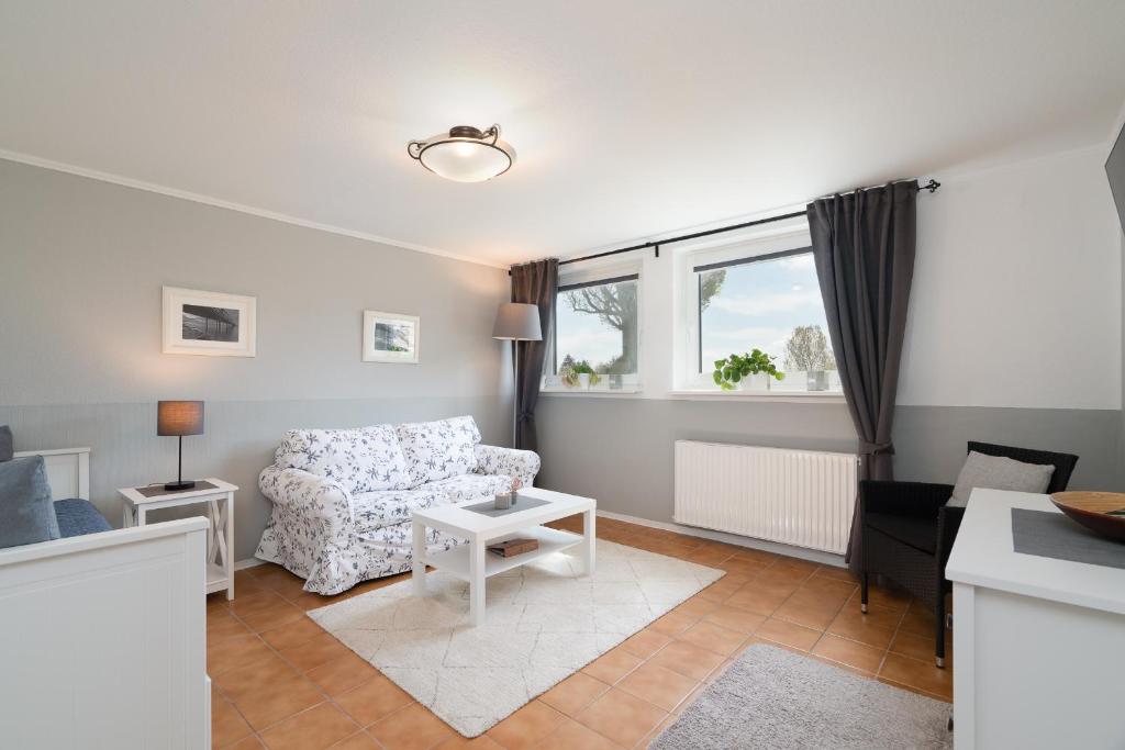 a living room with a couch and a chair at Wieschengrund in Neustadt in Holstein