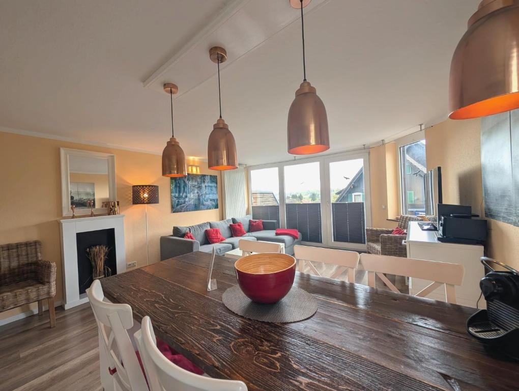 a dining room and living room with a table and chairs at Chalet Platzhirsch in Braunlage