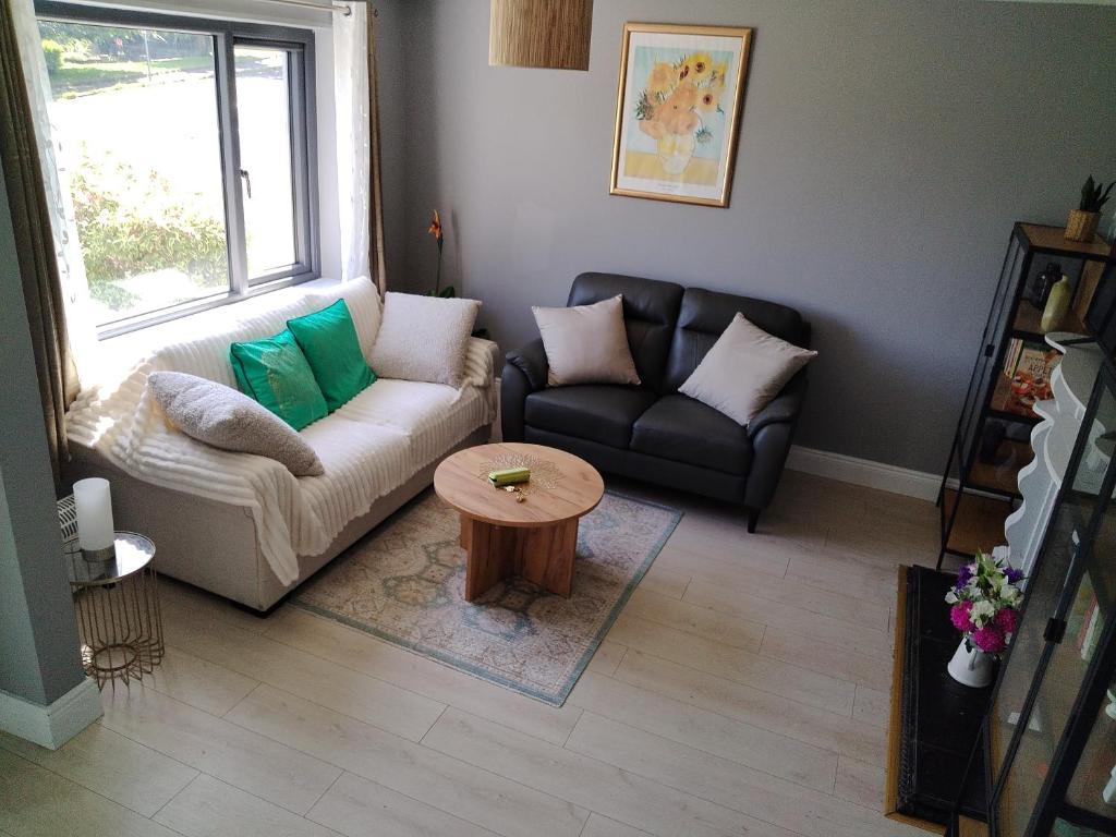 a living room with a couch and a table at Willow House in Newtownshandrum