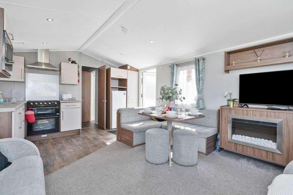 a living room with a couch and a table and a kitchen at Lovely 3 bedroom holiday home in Seton Sand caravan park Wi-Fi Xbox in Edinburgh
