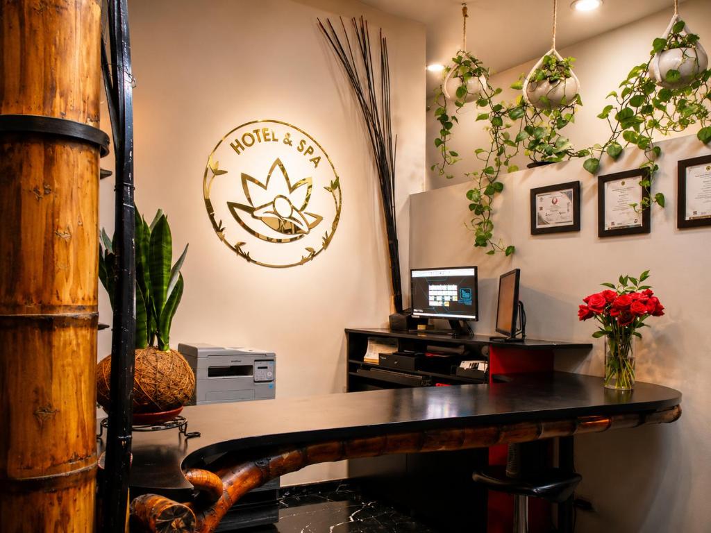 an office with a desk with a computer and plants at Zen Hotel Boutique in Bogotá