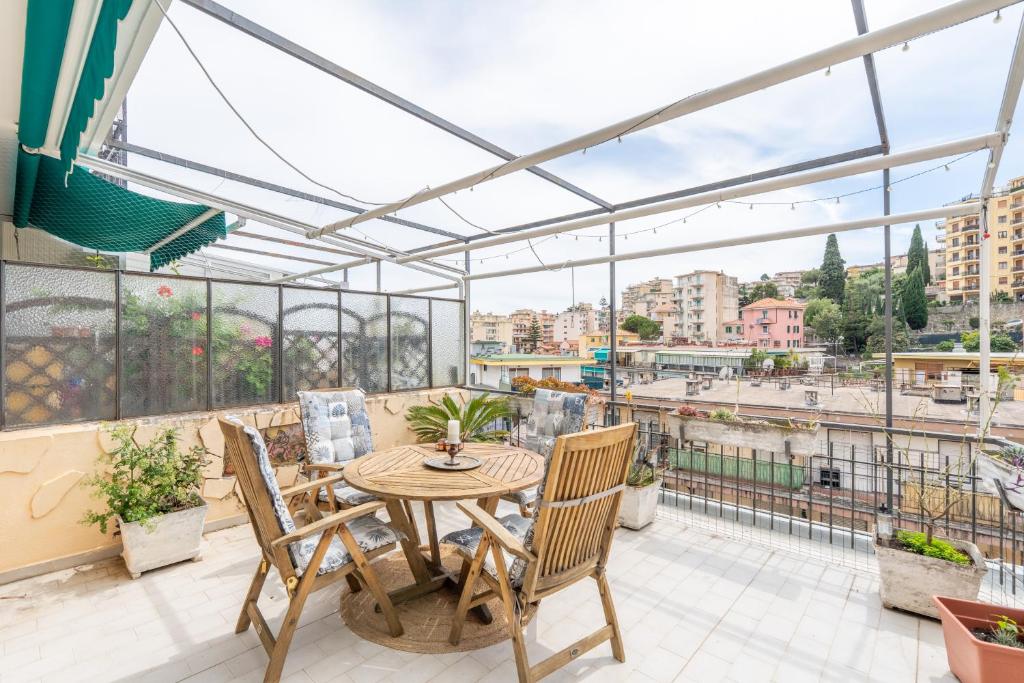 a patio with a table and chairs on a balcony at Casa Iris h Sanremo in Sanremo