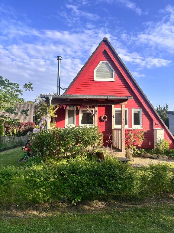 a red house with a red roof at Ferienhaus Wittensee in Bünsdorf