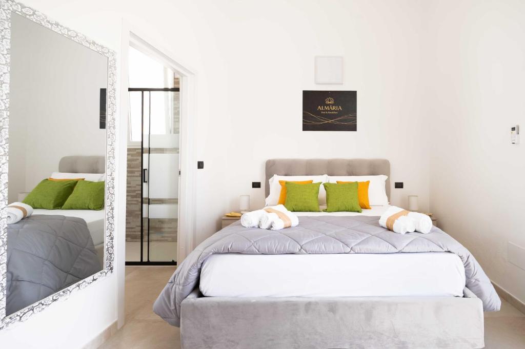 a bedroom with a bed and a mirror at Monolocale Aurea 5 in Nardò