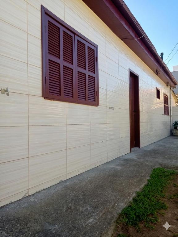 a wall of a building with a window and a door at Residencia Siqueira in Garopaba