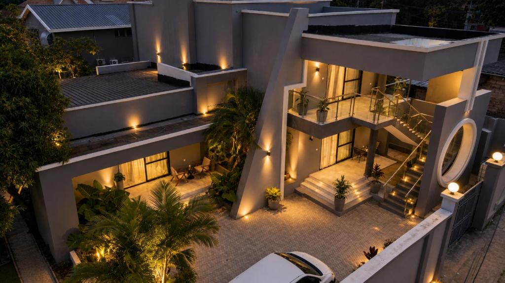 an aerial view of a house at night with lights at Care Appartement in Kinshasa