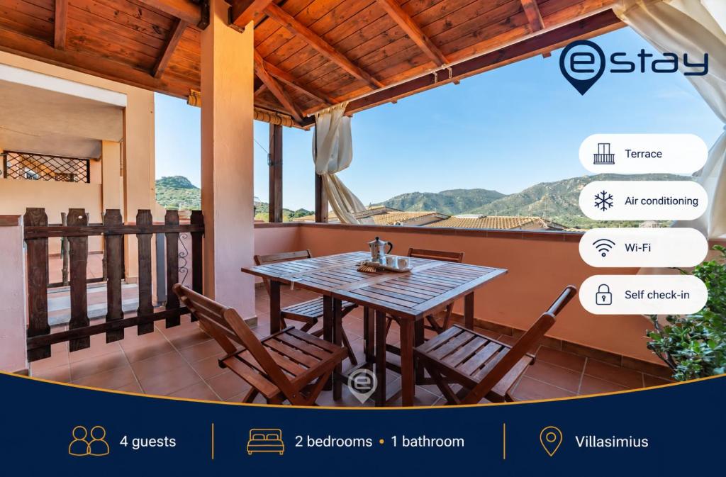 a table and chairs on the balcony of a house at Estay - La perla nel blu in Villasimius
