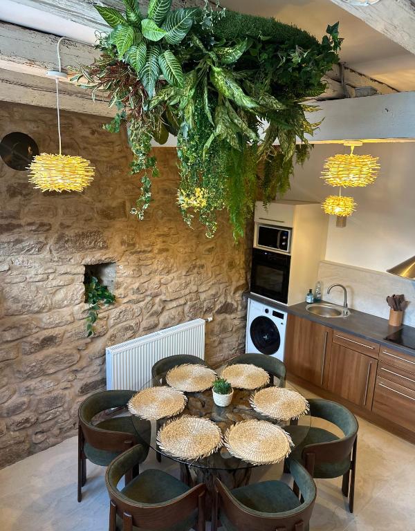 a kitchen with a table with stools and a kitchen with a kitchen at La Cabane in Dambach-la-Ville